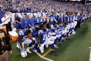 Indianapolis Colts players kneel during the national anthem to protest Donald Trump’s comments about NFL players.