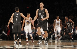 Photo  Brooklyn Nets guard Jeremy Lin (7) and Nets center Brook Lopez acknowledge a great play in first-half of game against the Golden State Warriors at the Barclays Center on December 22, 2016.