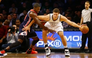 Brook Lopez dribbles ball past Wizards defender Andrew Nicholson (44) during first half on Monday, December 5, 2016 