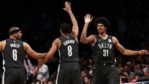 Brooklyn Nets players Jared Dudley (left), Spencer Dinwiddie (center), and Jarrett Allen giving each other high-fives during the Nets game against the Phoenix Suns on Sunday, December 23, 2018. The Nets won 111-103