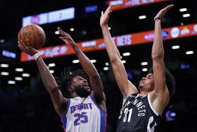Brooklyn Nets rookie center Jarrett Allen defends basket against Detroit Pistons guard Reggie Bullock.