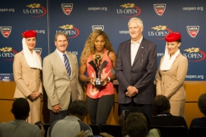 Legendary professional tennis player, Serena Williams, holding her prize from Emirates Airlines. Standing to Serena&#039;s right is David A. Haggerty, USTA, Chairman of the Board, CEO and President.