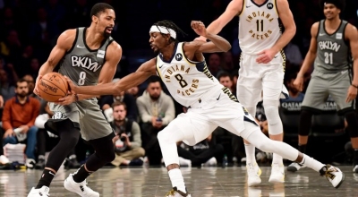 Brooklyn Nets guard Spencer Dinwiddie (left) defending the ball game against Indiana Pacers guard (#8) Justin Holiday at an NBA game at the Barclays Center, in Brooklyn, NY on November 18, 2019. The Brooklyn Nets lost 115-86.
