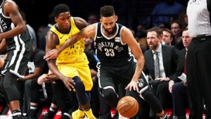 Brooklyn Nets shooting guard Allen Crabbe (right) defending ball against Indiana Pacers guard Victor Oladipo