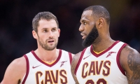 Cleveland Cavaliers PF/center (l) talking with teammate LeBron James. 