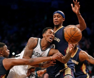 Brooklyn Nets forward Rondae Hollis-Jefferson (center) is double-teamed by two New Orleans Pelicans players, forward Terrence Jones on the left, and forward Dante Cunningham (33).  