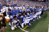 Indianapolis Colts players kneel during the national anthem to protest Donald Trump’s comments about NFL players.