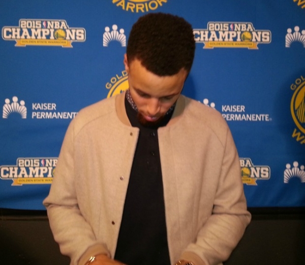 NBA MVP Stephen Curry checking his phone after press conference with the media after defeating the Brooklyn Nets 114-98 at the Barclays Center in Brooklyn