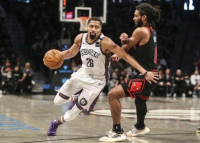Brooklyn Nets guard Spencer Dinwiddie (left) breezes by Chicago Bulls guard Colby White at an NBA game at the Barclays Center in Brooklyn, NY on March 8, 2020. The Brooklyn Nets defeated the Chicago Bulls 110-107. 