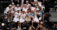 The San Antonio Spurs team with the winning 2014 NBA Championship trophy. The Spurs beat the Miami Heat 104-87