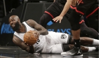 Brooklyn Nets' Quincy Acy, on the floor scrambling for the ball in a game against the Houston Rockets at the Barclays Center on Sunday, January 15, 2017.