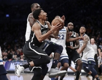 Brooklyn Nets' Spencer Dinwiddie, left, drives past Minnesota Timberwolves' Gorgui Dieng during an NBA basketball game on Wednesday, Jan. 3, 2018, at the Barclays Center in Brooklyn, New York. The Nets won 98-97.