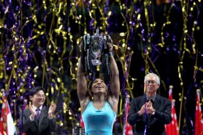 Serena Williams holding Billie Jean King trophy at the WTA Finals in Singapore