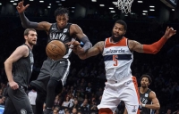 Photo  Rondae Hollis-Jefferson, Brooklyn Nets forward (center), competes for the ball with Washington Wizards' forward Markieff Morris (right) during the first half of an NBA basketball game Friday, Dec. 22, 2017, at the Barclays Center in Brooklyn, NY. 