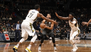 Allen Crabbe (center), Brooklyn Nets shooting guard, taking a shot surrounded by Pacers Thaddeus Young (left) and Victor Oladipo (right)