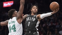Brooklyn Nets point guard D'Angelo Russell, holds off defense from Robert Williams III in a game against the Boston Celtics at the Barclays Center on March 30, 2019. The Brooklyn Nets defeated the Boston Celtics 110-96.