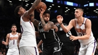 D'Angelo Russell, who led all scorers with 33 points in Nets loss to the Phoenix Suns, defending the ball against two Phoenix players