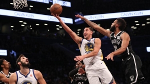 Brooklyn Nets guard Allen Crabbe (right) trying to stop Golden State Warriors guard Klay Thompson from scoring in a game at the Barclays Center on Sunday.