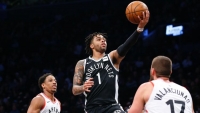 Brooklyn Nets guard D'Angelo Russell (center) goes to the basket against Toronto Raptors guard DeMar DeRozan (left) and center Jonas Valanciunas (right) during second half at Barclays Center; Brooklyn, NY, USA; on March 13, 2018. 