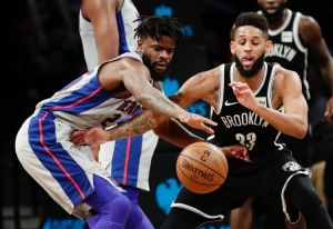 Brooklyn Nets&#039; Allen Crabbe and Detroit Pistons&#039; Reggie Bullock struggle for control of the ball.