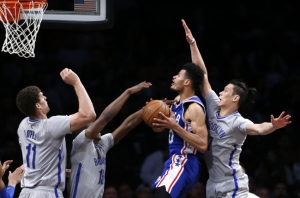 Brooklyn Nets center Brook Lopez (11) and guard Isaiah Whitehead (15) and guard Jeremy Lin (7) defending Philadelphia 76ers guard Timothe Luwawu-Cabarrot (20) during game at Barclays Center on March 28, 2017. 