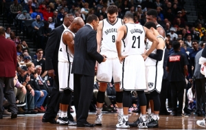 Brooklyn Nets head coach Lionel Hollins talking with his team during a timeout of the Nets game against the Dallas Mavericks at Barclays Center on December 23, 2015.