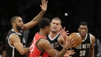 Brooklyn Nets center Brook Lopez putting defensive moves on Toronto Raptors' DeMar DeRozan