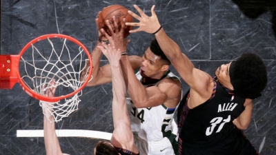 Brooklyn Nets players surround Giannis Antetokounmpo of Milwaukee Bucks in attempt to prevent Antetokounmpo from scoring. The Bucks defeated the Nets 113-94 at the Barclays Center on Monday, February 4, 2019.