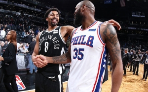 Brooklyn Nets point guard Spencer Dinwiddie shaking hands with former teammate Trevor Booker, who is now a forward with the Philadelphia 76ers.