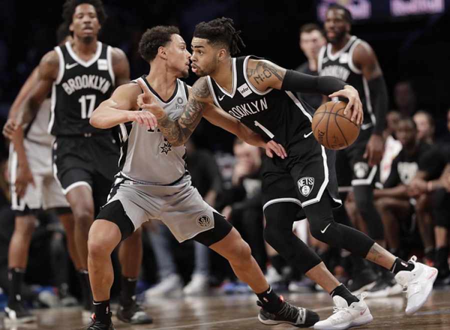 Brooklyn Nets guard D’Angelo Russell drives past San Antonio Spurs guard Bryn Forbes on the road to a Nets 101-85 victory over the Spurs